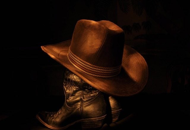 The Cowboys Logo Is Depicted On A Leather Cowboy Hat Background